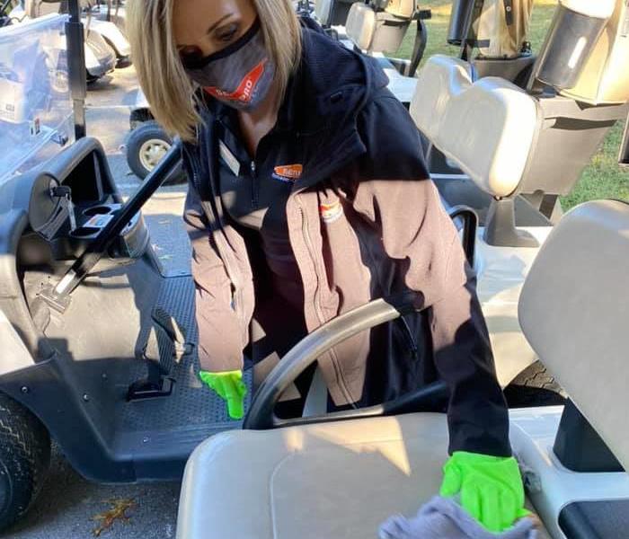 girl cleaning golf cart
