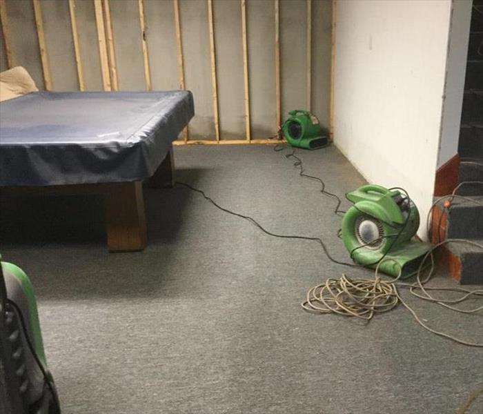 green air mover on grey carpet